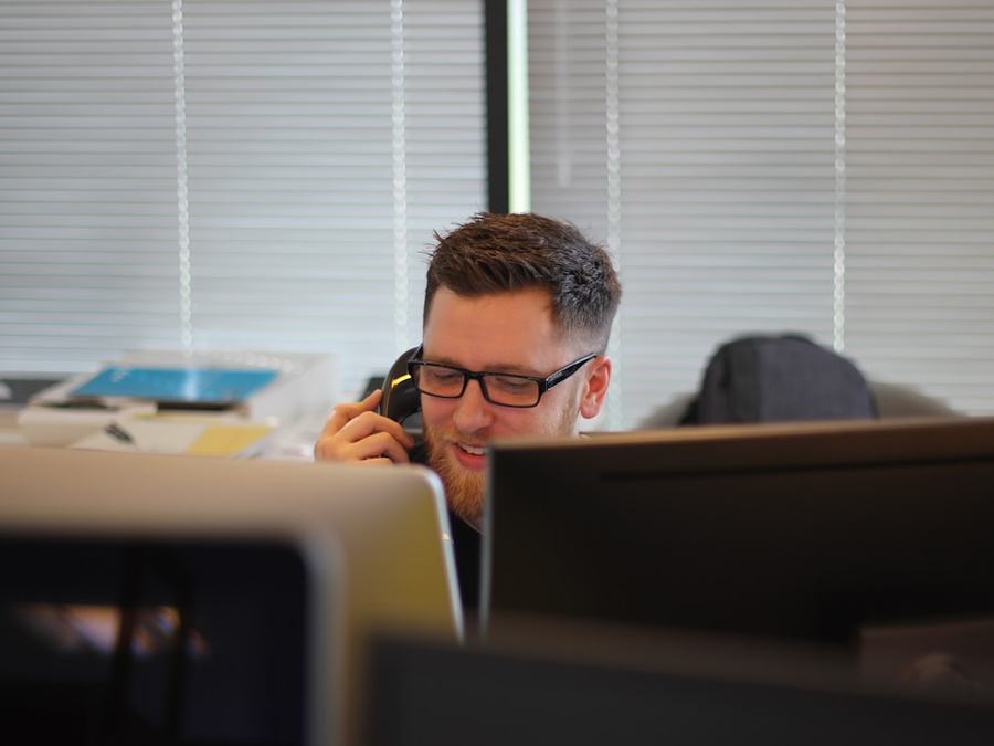 Contact centre operator taking a payment call on a desk telephone